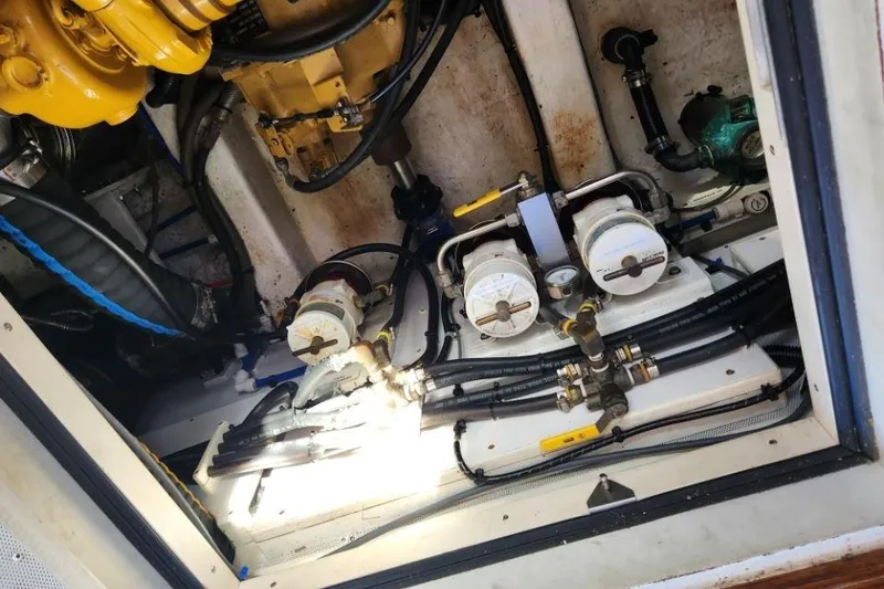 Slide: The Image of Engine room of a 2008 Bruckmann 50 MKII yacht, showcasing mechanical components and fuel filters. - 49