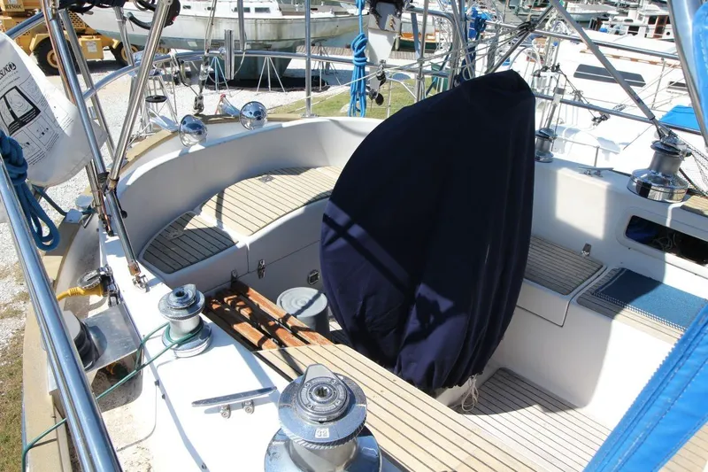 Slide: The Image of 1987 Slocum 43 sailboat cockpit with covered wheel and teak seating. - 10