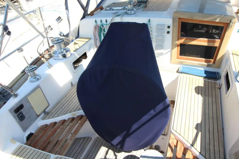 Slide: The Image of Cockpit of 1987 Slocum 43 sailboat with covered wheel and wooden accents. - 11