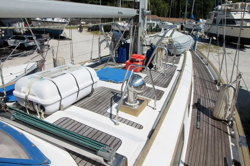 Slide: The Image of 1987 Slocum 43 sailboat deck with lifeboat and equipment in marina. - 13