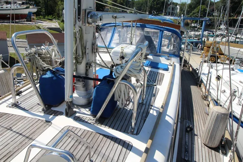 Slide: The Image of 1987 Slocum 43 sailboat deck with ropes and equipment in a marina setting. - 15