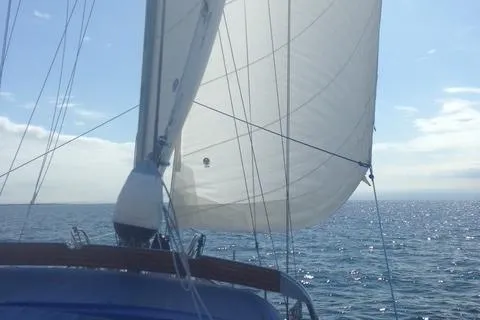 Slide: The Image of Sailing on a 1987 Slocum 43 yacht with full sails on a sunny day. - 16