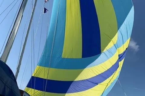 Slide: The Image of Colorful sail on a 1987 Slocum 43 yacht against a clear blue sky. - 17