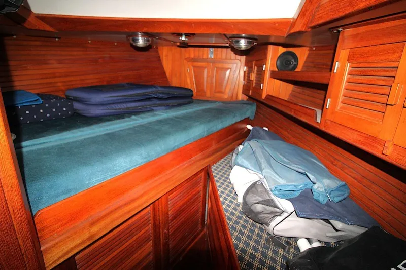 Slide: The Image of Cozy cabin interior of 1987 Slocum 43 sailboat with wooden finish and bedding. - 24