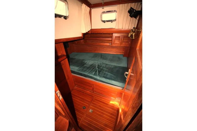 Slide: The Image of Cozy cabin interior of 1987 Slocum 43 sailboat with wooden finish and porthole windows. - 27