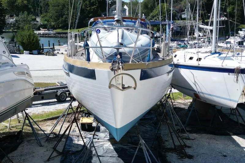 Slide: The Image of 1987 Slocum 43 sailboat on stands in a marina, surrounded by other boats. - 5