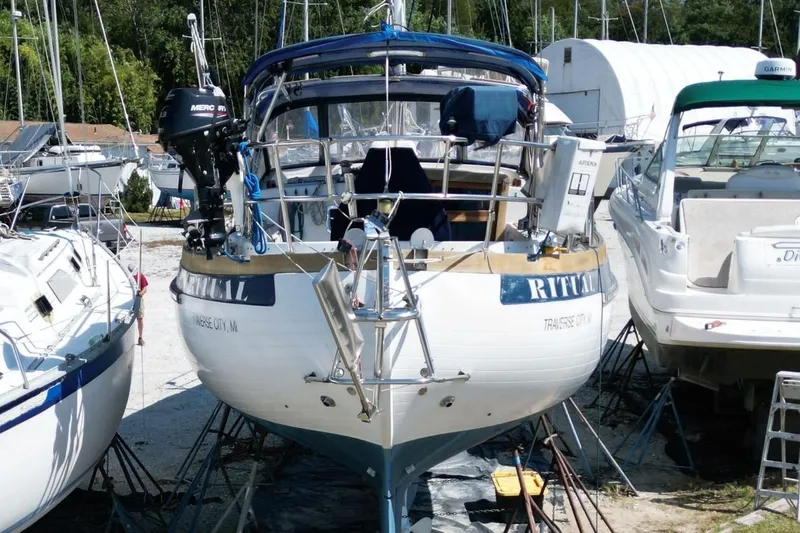 Slide: The Image of 1987 Slocum 43 sailboat in dry dock, surrounded by other boats. - 6