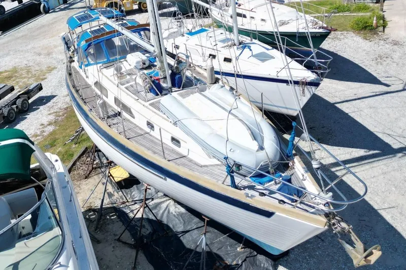 Slide: The Image of 1987 Slocum 43 sailboat on dry dock, surrounded by other boats. - 8
