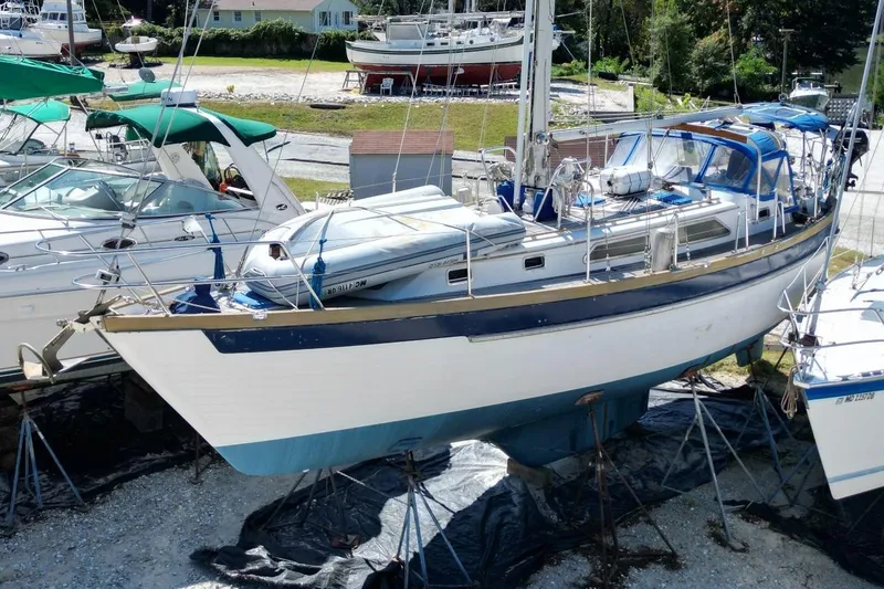 Slide: The Image of 1987 Slocum 43 sailboat on stands, surrounded by other boats in a marina. - 9