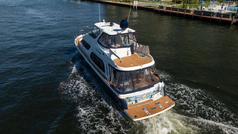Slide: The Image of 2005 Carver 56 Voyager yacht cruising on a river, aerial view. - 10
