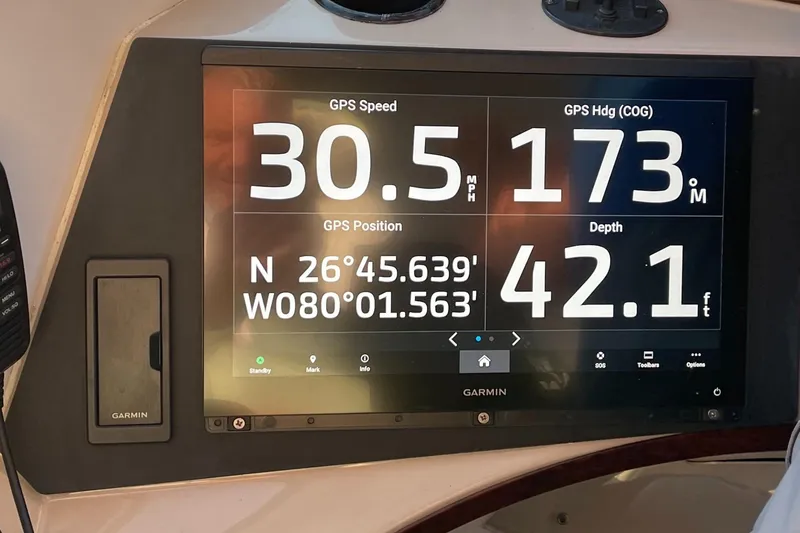 Slide: The Image of Garmin GPS display on 2005 Carver 56 Voyager showing speed, heading, position, and depth. - 13