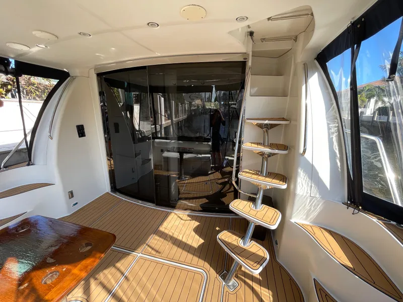 Slide: The Image of Interior of 2005 Carver 56 Voyager yacht with wooden flooring and spiral staircase. - 17