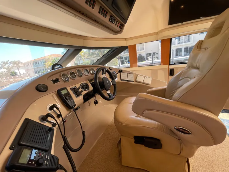 Slide: The Image of Captain's helm of 2005 Carver 56 Voyager yacht with leather seat and control panel. - 24