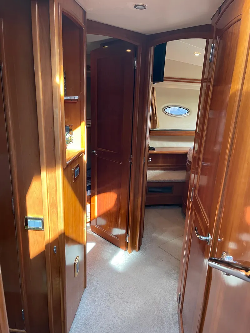 Slide: The Image of Interior of 2005 Carver 56 Voyager yacht with wooden cabinetry and carpeted flooring. - 28