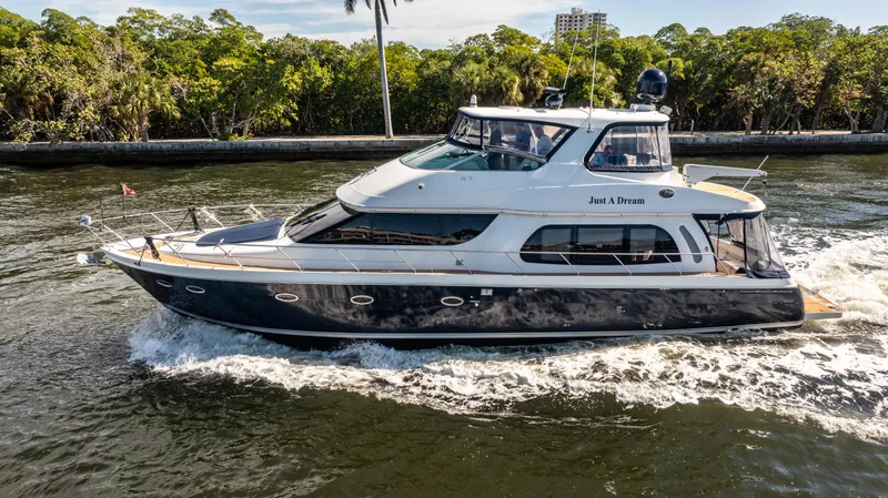 Slide: The Image of 2005 Carver 56 Voyager yacht cruising on a scenic waterway. - 3