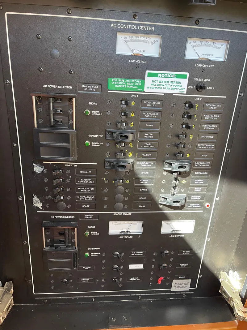 Slide: The Image of Control panel of a 2005 Carver 56 Voyager yacht, featuring various switches and indicators. - 33