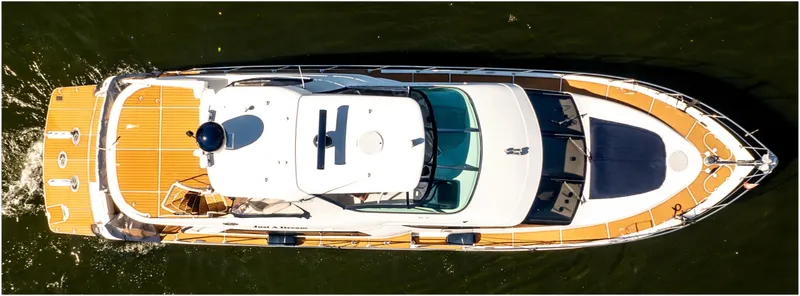 Slide: The Image of Aerial view of 2005 Carver 56 Voyager yacht cruising on water. - 7