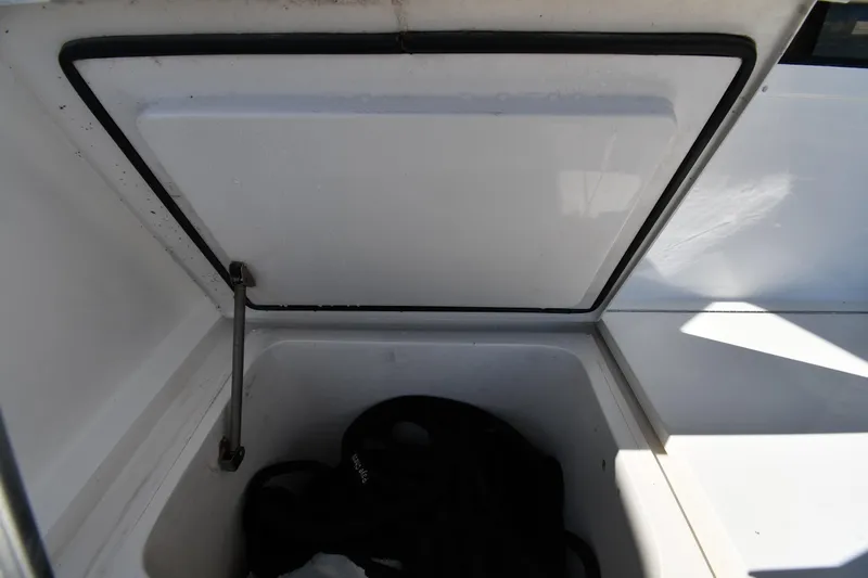 Slide: The Image of Open storage compartment on a 1996 Viking 53 Convertible boat. - 14