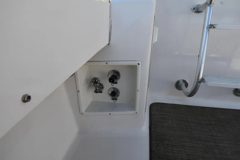 Slide: The Image of 1996 Viking 53 Convertible yacht deck with utility panel and ladder. - 15