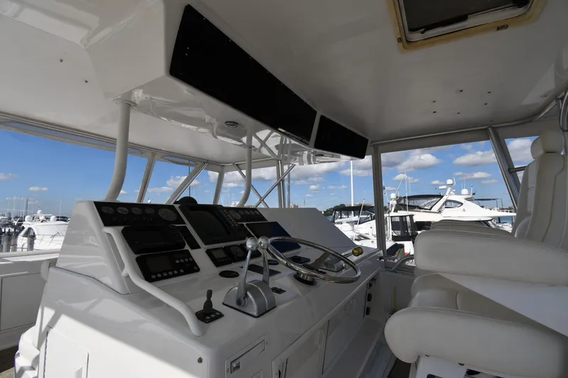 Slide: The Image of Helm of 1996 Viking 53 Convertible yacht with modern controls and white seating. - 18