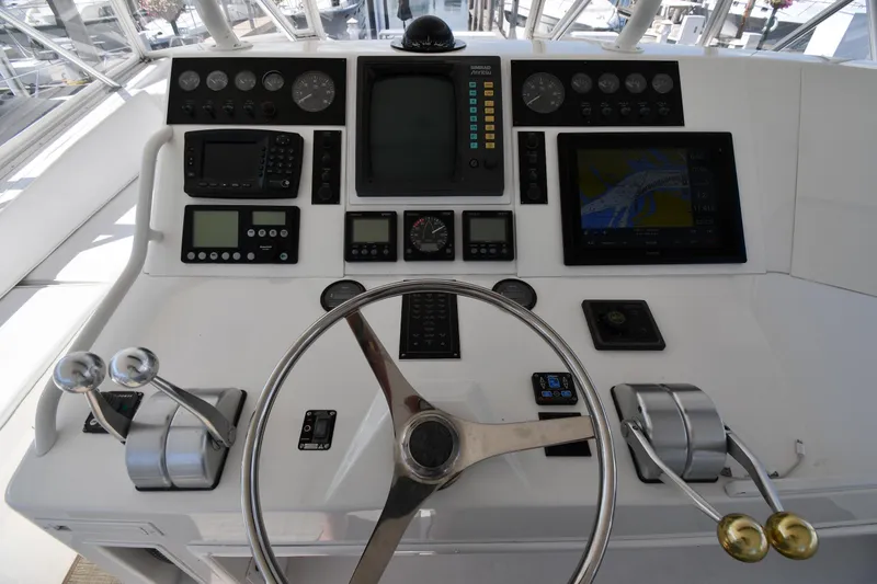 Slide: The Image of Helm of 1996 Viking 53 Convertible yacht with navigation instruments and steering wheel. - 19