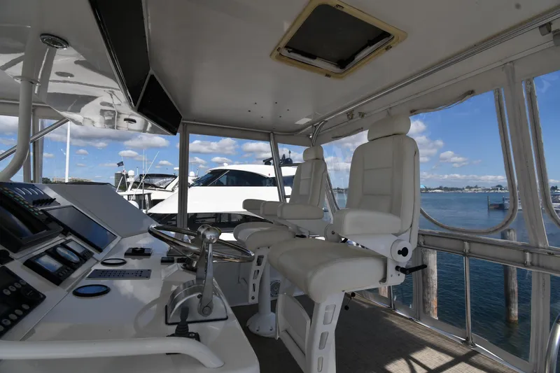 Slide: The Image of Interior of a 1996 Viking 53 Convertible yacht with helm and white captain chairs. - 21
