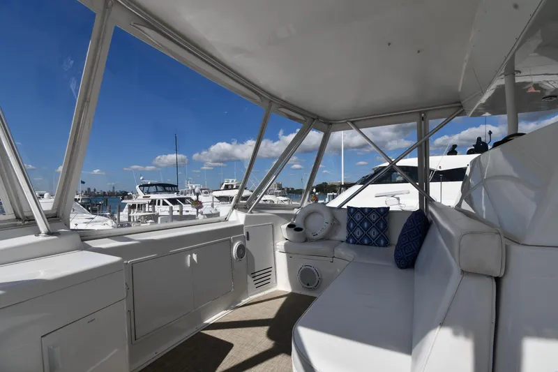 Slide: The Image of Interior view of 1996 Viking 53 Convertible yacht with marina backdrop. - 25