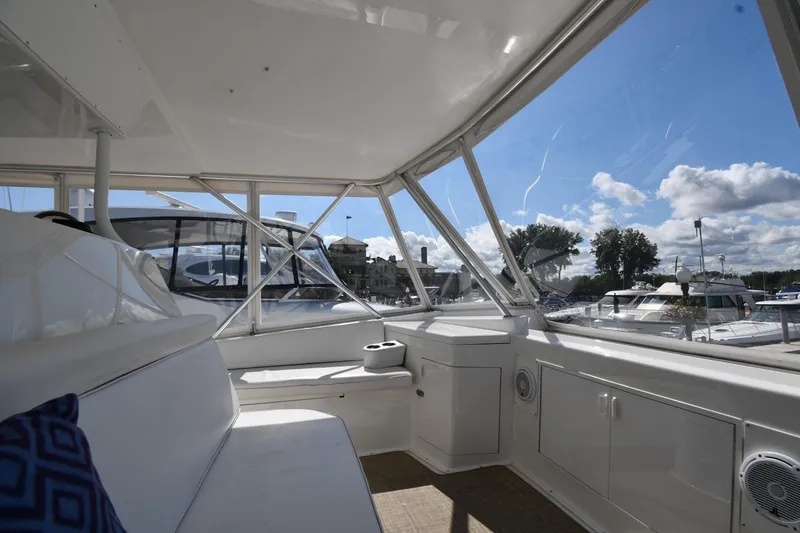 Slide: The Image of Interior view of 1996 Viking 53 Convertible yacht with marina backdrop. - 26