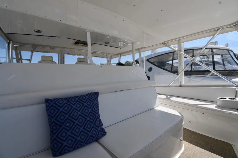 Slide: The Image of Interior of 1996 Viking 53 Convertible yacht with white seating and blue patterned pillow. - 27
