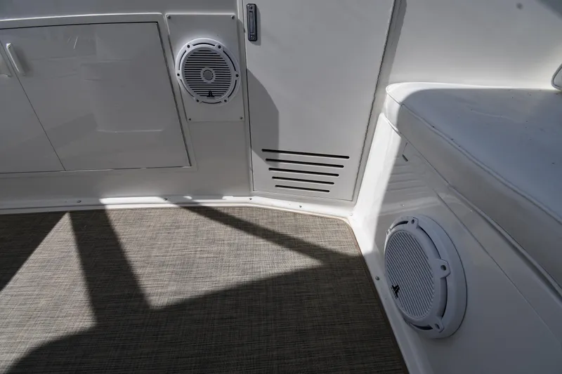 Slide: The Image of Interior of a 1996 Viking 53 Convertible yacht, featuring speakers and seating. - 29