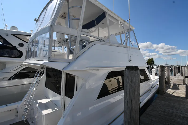Slide: The Image of 1996 Viking 53 Convertible yacht docked at marina under clear blue sky. - 3