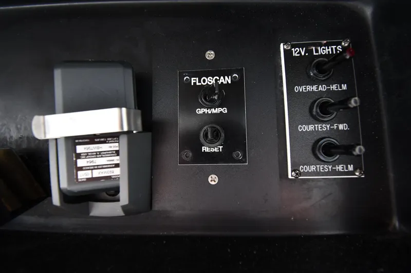 Slide: The Image of Control panel of a 1996 Viking 53 Convertible boat with Floscan and light switches. - 37
