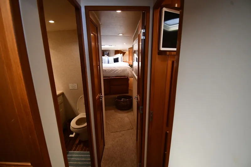 Slide: The Image of Interior of 1996 Viking 53 Convertible yacht, featuring cozy bedroom and bathroom. - 39
