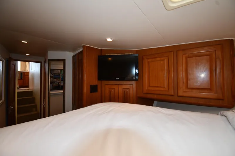 Slide: The Image of Interior of 1996 Viking 53 Convertible yacht with wood cabinets and mounted TV. - 43
