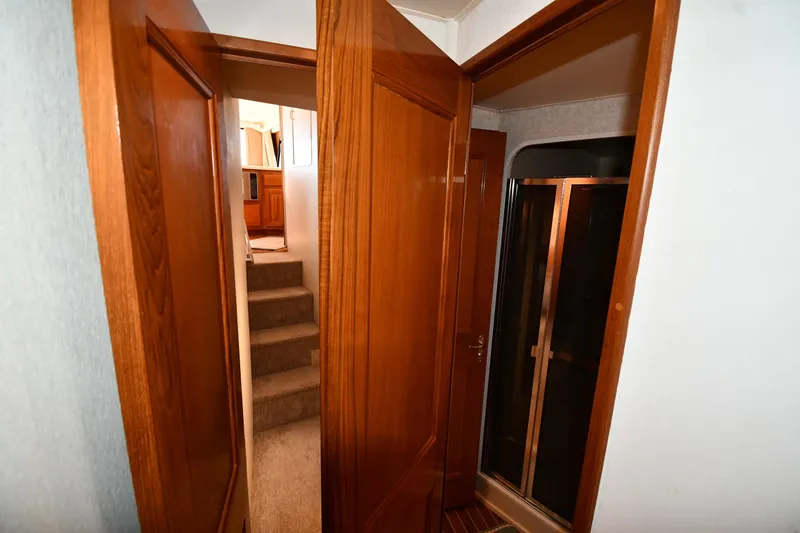 Slide: The Image of Interior of 1996 Viking 53 Convertible yacht with wooden doors and carpeted stairs. - 46