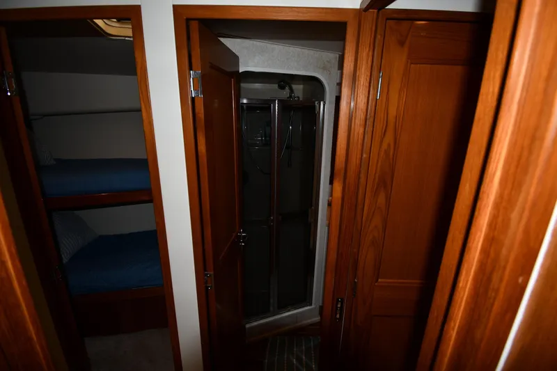 Slide: The Image of Interior of 1996 Viking 53 Convertible yacht with wooden doors and bunk beds. - 47