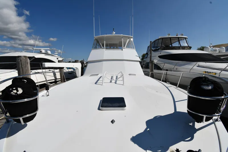 Slide: The Image of 1996 Viking 53 Convertible yacht docked under clear blue sky. - 5