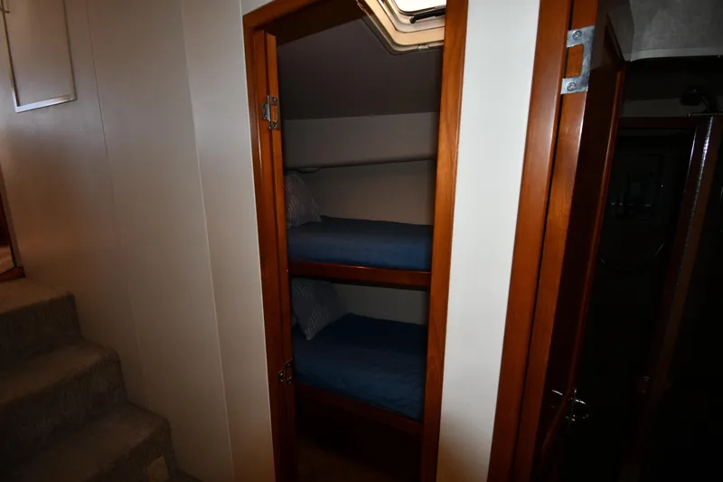 Slide: The Image of Bunk beds in a 1996 Viking 53 Convertible yacht cabin with wooden trim. - 50