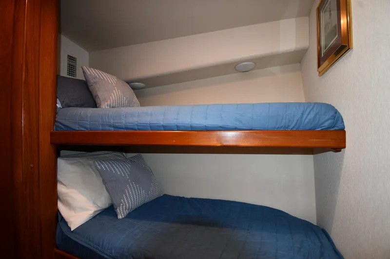 Slide: The Image of Bunk beds in 1996 Viking 53 Convertible yacht cabin with blue bedding. - 51