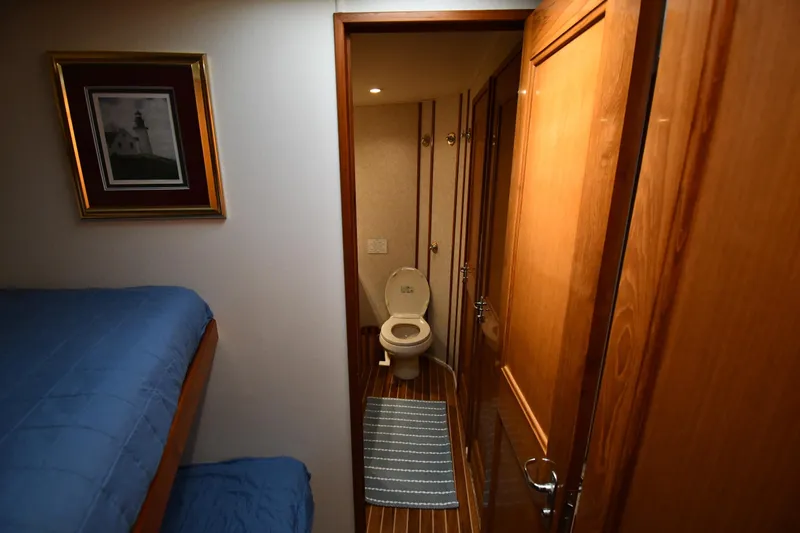 Slide: The Image of Interior of 1996 Viking 53 Convertible yacht showing bathroom and bunk bed. - 52