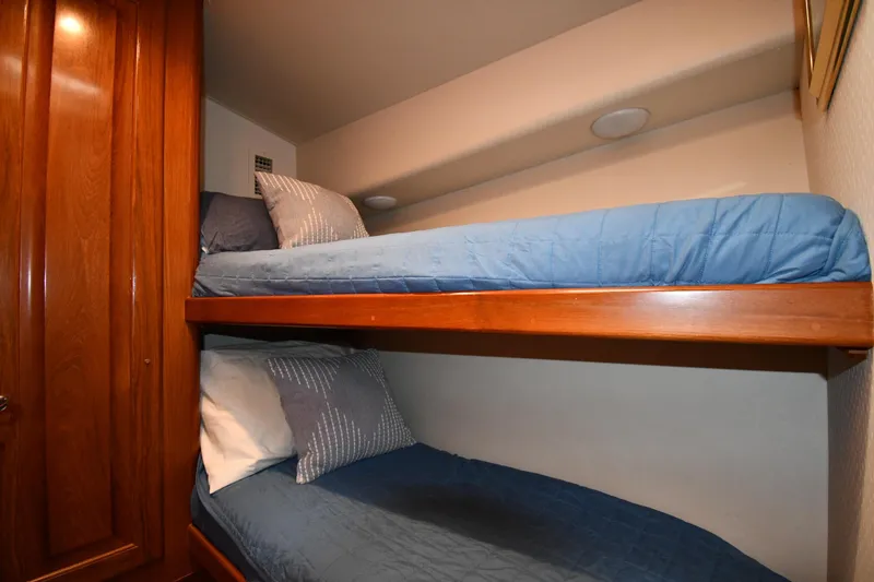 Slide: The Image of Bunk beds with blue bedding in 1996 Viking 53 Convertible yacht cabin. - 53