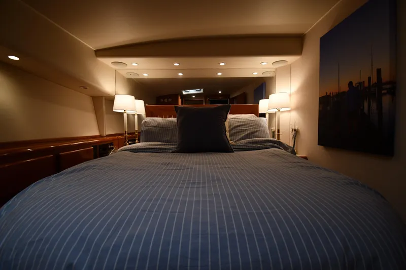 Slide: The Image of Luxurious bedroom interior of 1996 Viking 53 Convertible yacht with cozy lighting. - 55