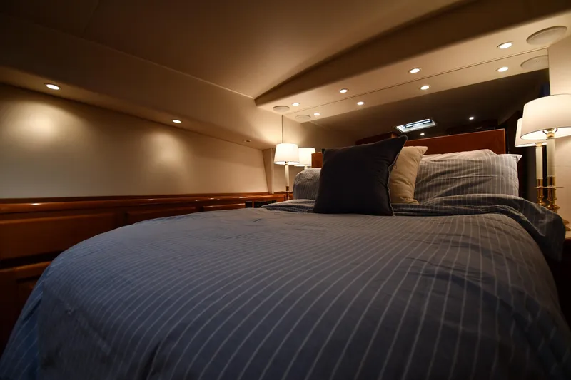 Slide: The Image of Luxurious bedroom interior of 1996 Viking 53 Convertible yacht with elegant lighting. - 56