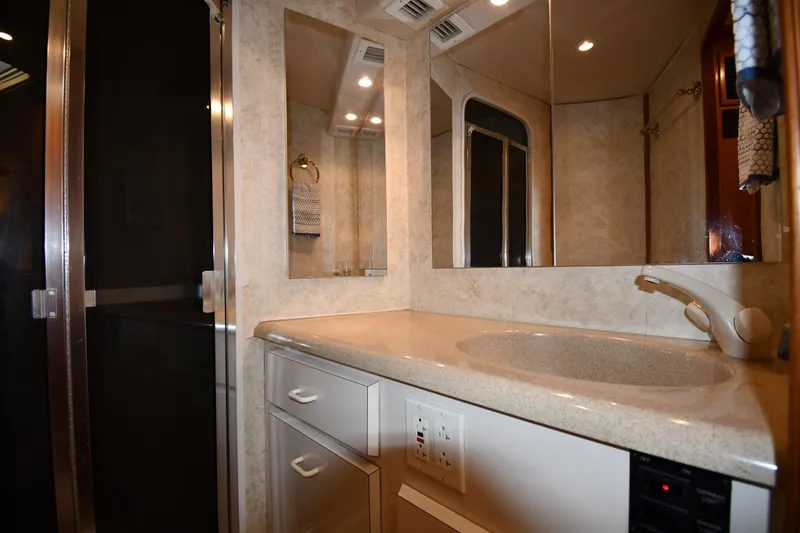 Slide: The Image of Bathroom interior of 1996 Viking 53 Convertible yacht with sink and mirror. - 61