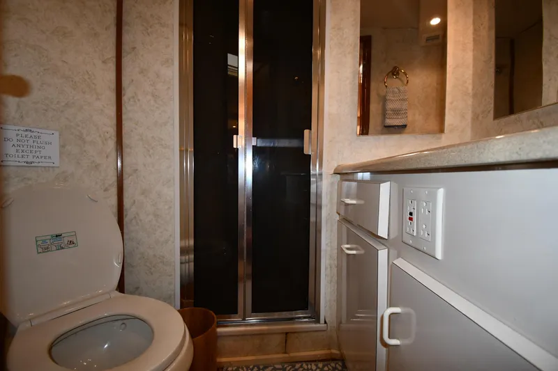 Slide: The Image of Bathroom interior of 1996 Viking 53 Convertible yacht with shower and toilet. - 63