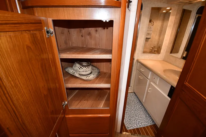 Slide: The Image of Interior of 1996 Viking 53 Convertible yacht with wooden cabinet and bathroom view. - 64