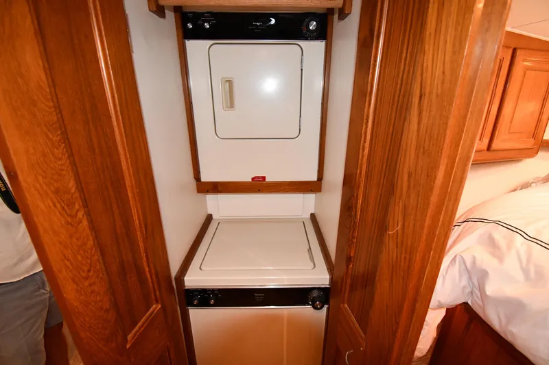 Slide: The Image of Laundry area with stacked washer and dryer in 1996 Viking 53 Convertible yacht. - 65