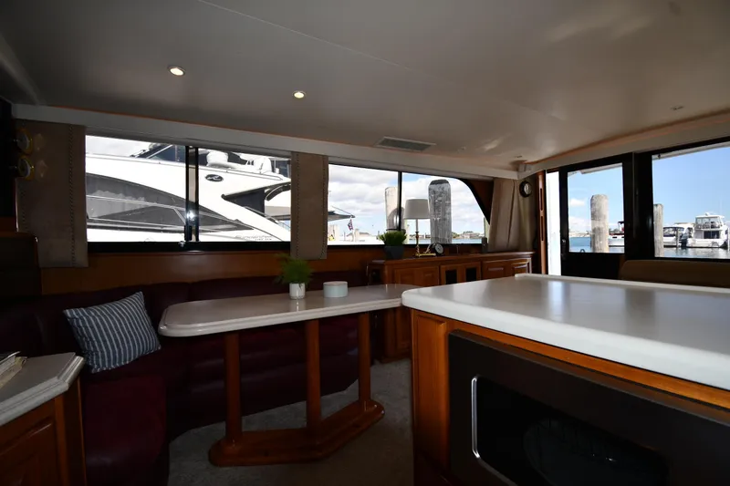 Slide: The Image of Interior of 1996 Viking 53 Convertible yacht with elegant seating and large windows. - 69