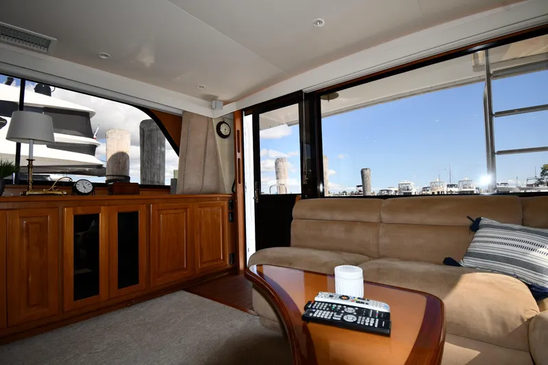 Slide: The Image of Interior of 1996 Viking 53 Convertible yacht with cozy seating and wooden cabinetry. - 70
