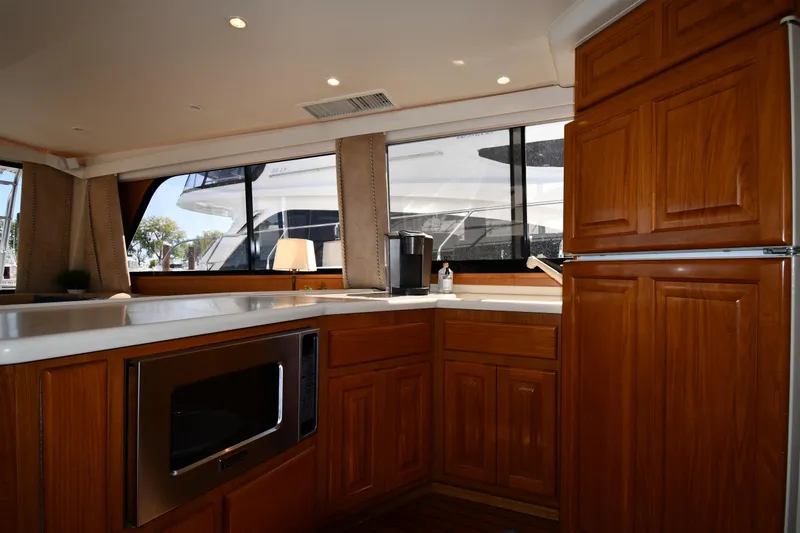 Slide: The Image of Interior of 1996 Viking 53 Convertible yacht kitchen with wooden cabinets and modern appliances. - 72
